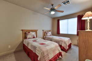 Carpeted bedroom with visible vents, ceiling fan, a textured ceiling, and baseboards
