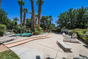 Community pool with a patio and fence