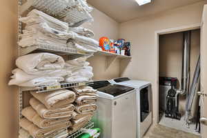 Washroom featuring laundry area and independent washer and dryer