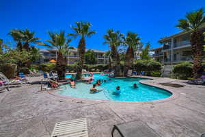 Community pool with a patio
