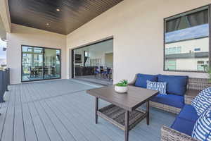 Wooden terrace featuring an outdoor living space