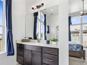 Ensuite bathroom featuring visible vents, ensuite bathroom, vanity, baseboards, and tile patterned floors