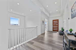 Entrance foyer featuring baseboards, wood finished floors, and recessed lighting