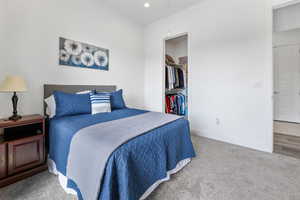Bedroom with carpet, recessed lighting, a closet, a spacious closet, and baseboards