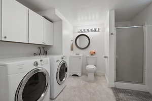 Basement level en suite bathroom with washer and dryer.