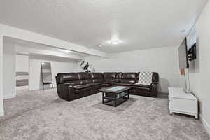 Large basement living room with brick accent wall.