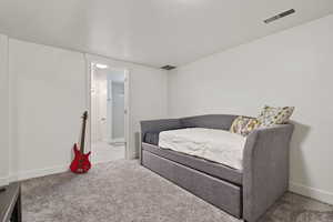 Basement level bedroom with closet and en suite bathroom