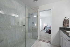 Primary Bedroom ensuite bathroom featuring granite countertops, double vanity, and an extra large walk in shower with dual shower heads.