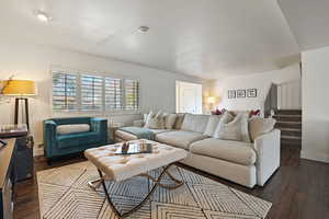 Living room view with LVP flooring and stairs up to level 2 and bedrooms.