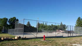 View of sport court featuring fence