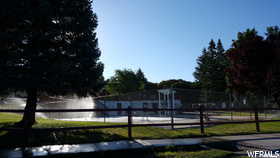 Surrounding community featuring a water view and fence