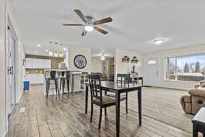 Dining room featuring baseboards, recessed lighting, light wood-style flooring, and a ceiling fan