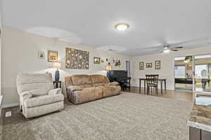 Living area featuring a textured ceiling, visible vents, and baseboards