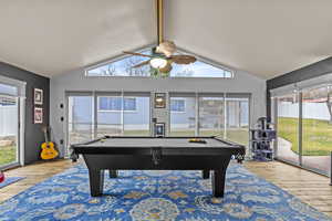 Game room featuring a ceiling fan, lofted ceiling, pool table, and hardwood / wood-style flooring