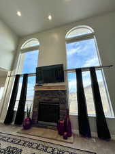 Family room with a wealth of natural light, a fireplace, baseboards, and recessed lighting