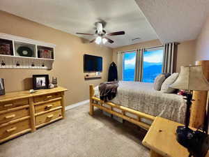 Bedroom 2 featuring baseboards, visible vents, ceiling fan