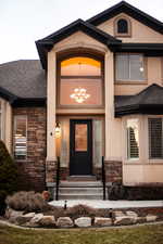 View of exterior entry with stone siding,