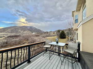 Deck featuring outdoor dining space and a mountain view looking East