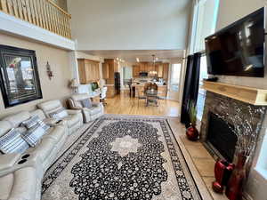 Living area with a high ceiling and a premium fireplace