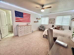 Southwest Bedroom featuring a textured ceiling, ceiling fan, and visible vents