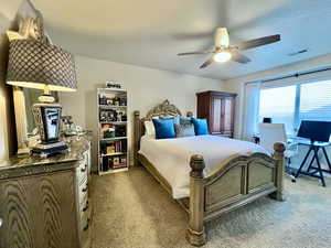 En-suite Bedroom with ceiling fan, visible vents, and a textured ceiling