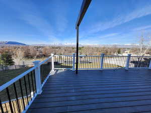 Wooden terrace featuring a mountain view and fence