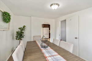 Dining space with arched walkways and baseboards