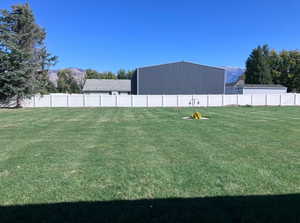 View of yard featuring fence and a mountain view