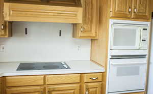 Kitchen featuring white appliances and light countertops