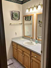 Bathroom featuring vanity and tile patterned floors