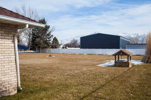 View of yard with fence and a mountain view