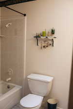 Bathroom featuring bathing tub / shower combination and toilet