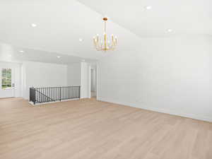 Empty room with recessed lighting, a chandelier, and light wood-style flooring