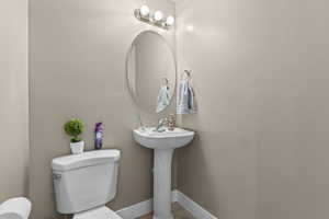 Bathroom featuring toilet and baseboards