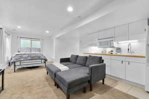 Living room with recessed lighting, visible vents, and light tile patterned flooring