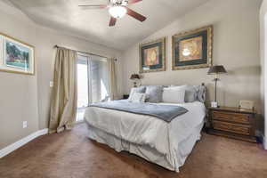 Carpeted bedroom with a textured ceiling, ceiling fan, baseboards, vaulted ceiling, and access to outside