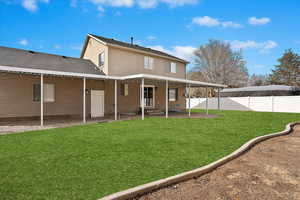 Back of house with a yard, a shingled roof, a patio area, and fence private yard