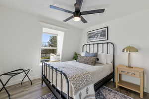 Bedroom with a ceiling fan, baseboards, and wood finished floors