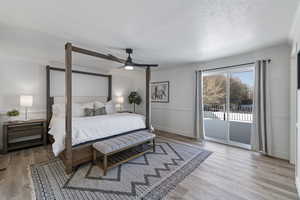 Bedroom with access to exterior, crown molding, and wood finished floors
