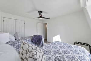 Bedroom with baseboards, a ceiling fan, a closet, and wood finished floors