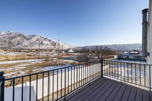 Snow covered deck with a mountain view
