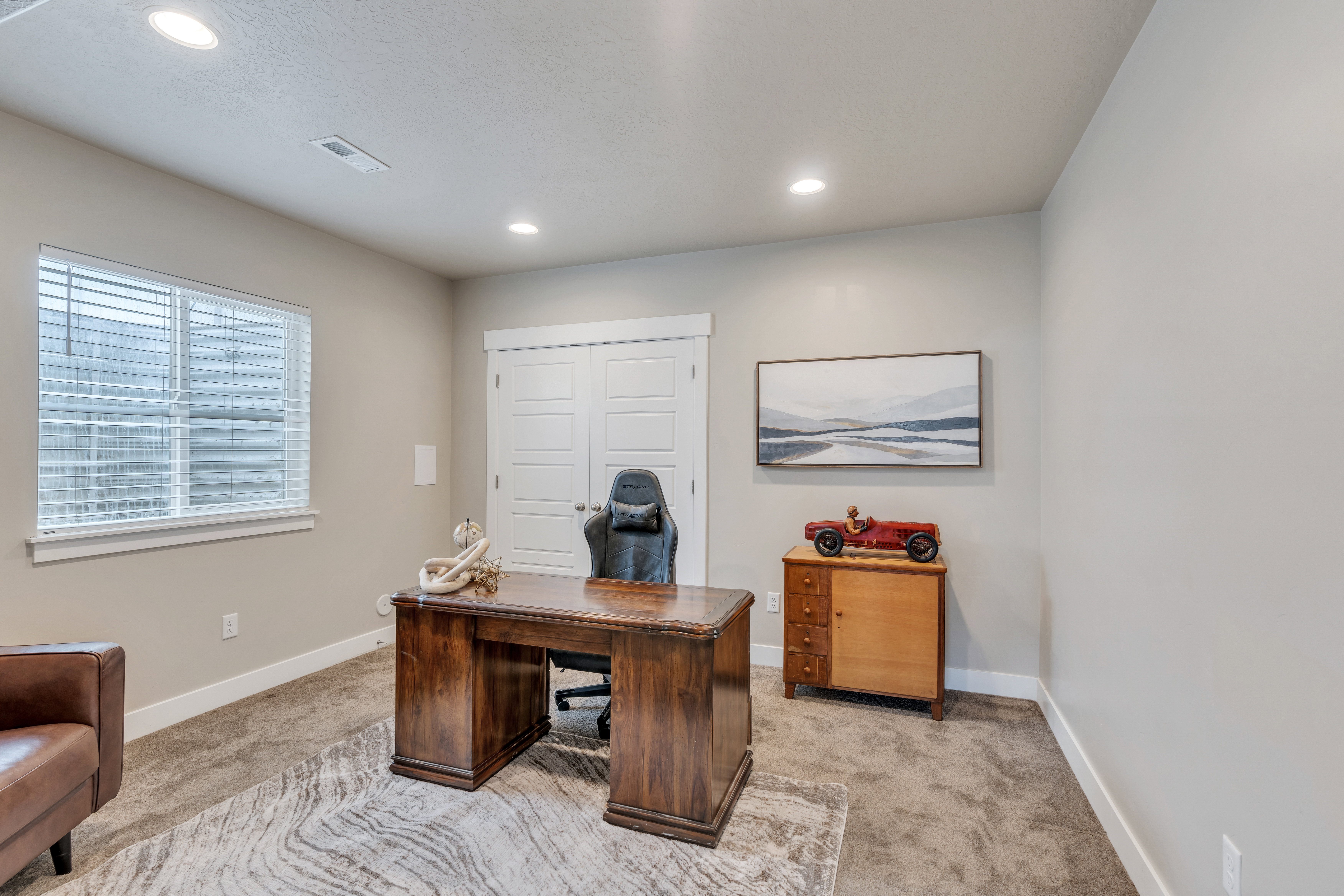 Office area featuring recessed lighting, light carpet, visible vents, and baseboards
