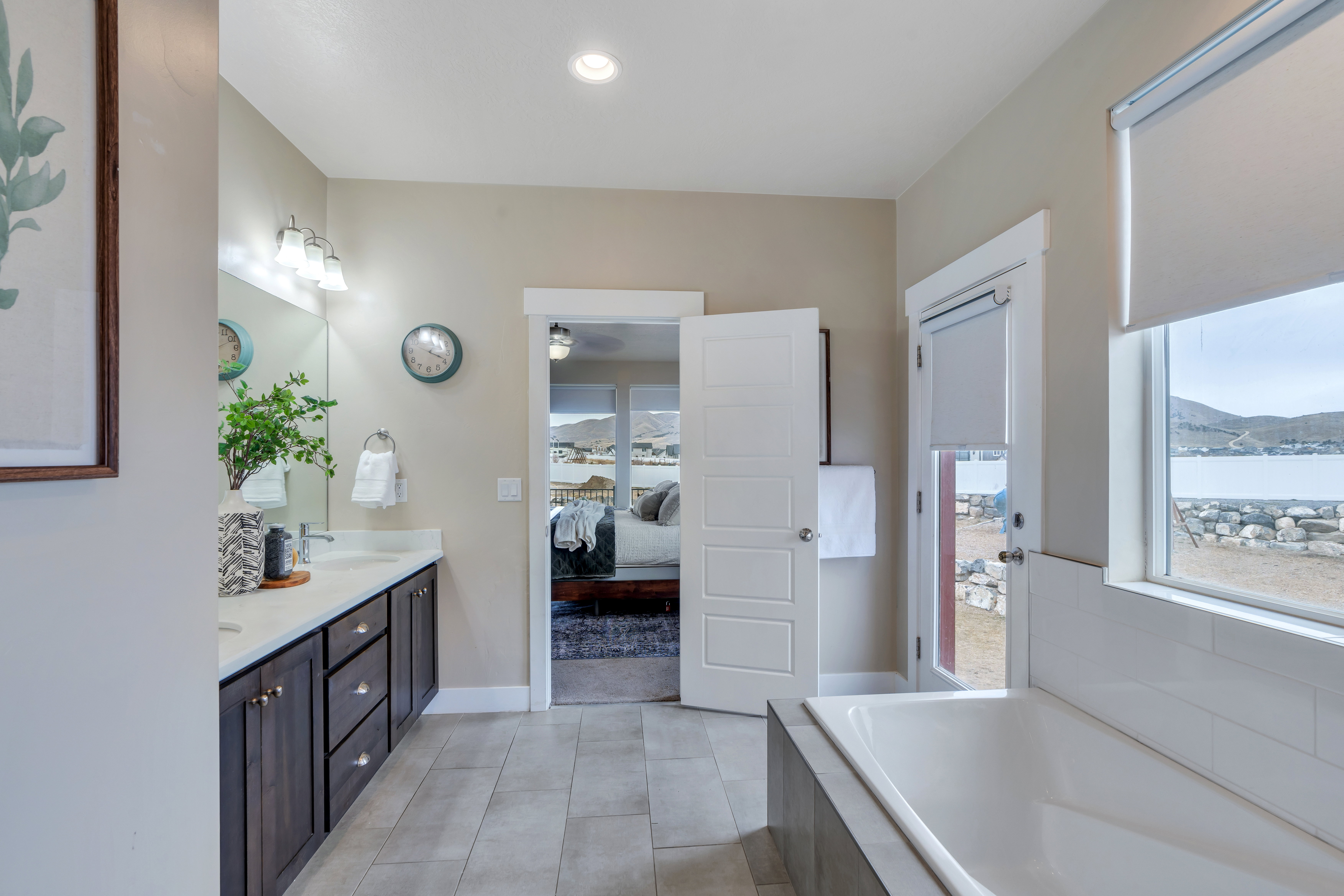 Bathroom featuring double vanity, plenty of natural light, a sink, and ensuite bathroom