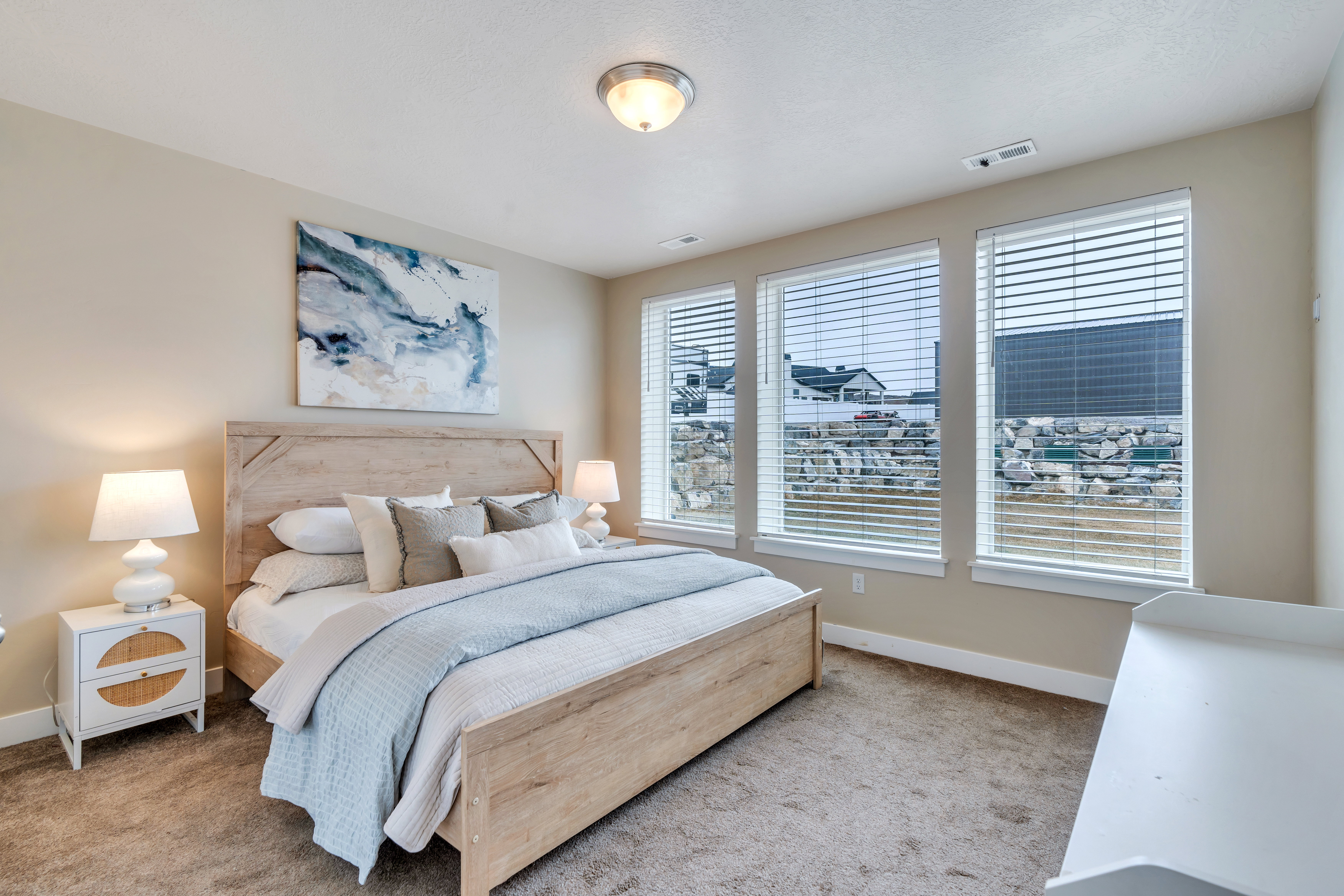 Carpeted bedroom featuring visible vents and baseboards