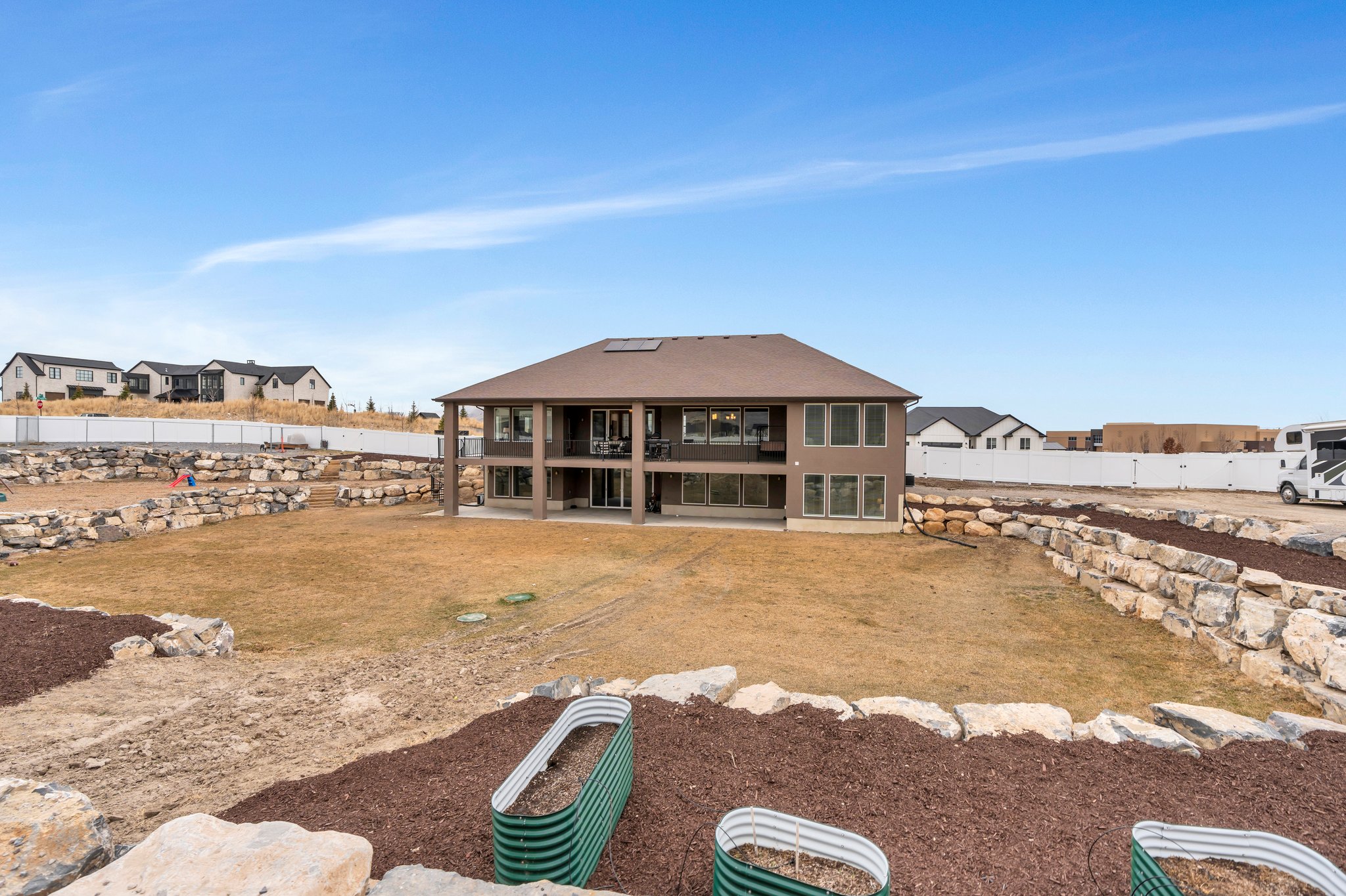 Rear view of property with a patio area, fence, and a yard