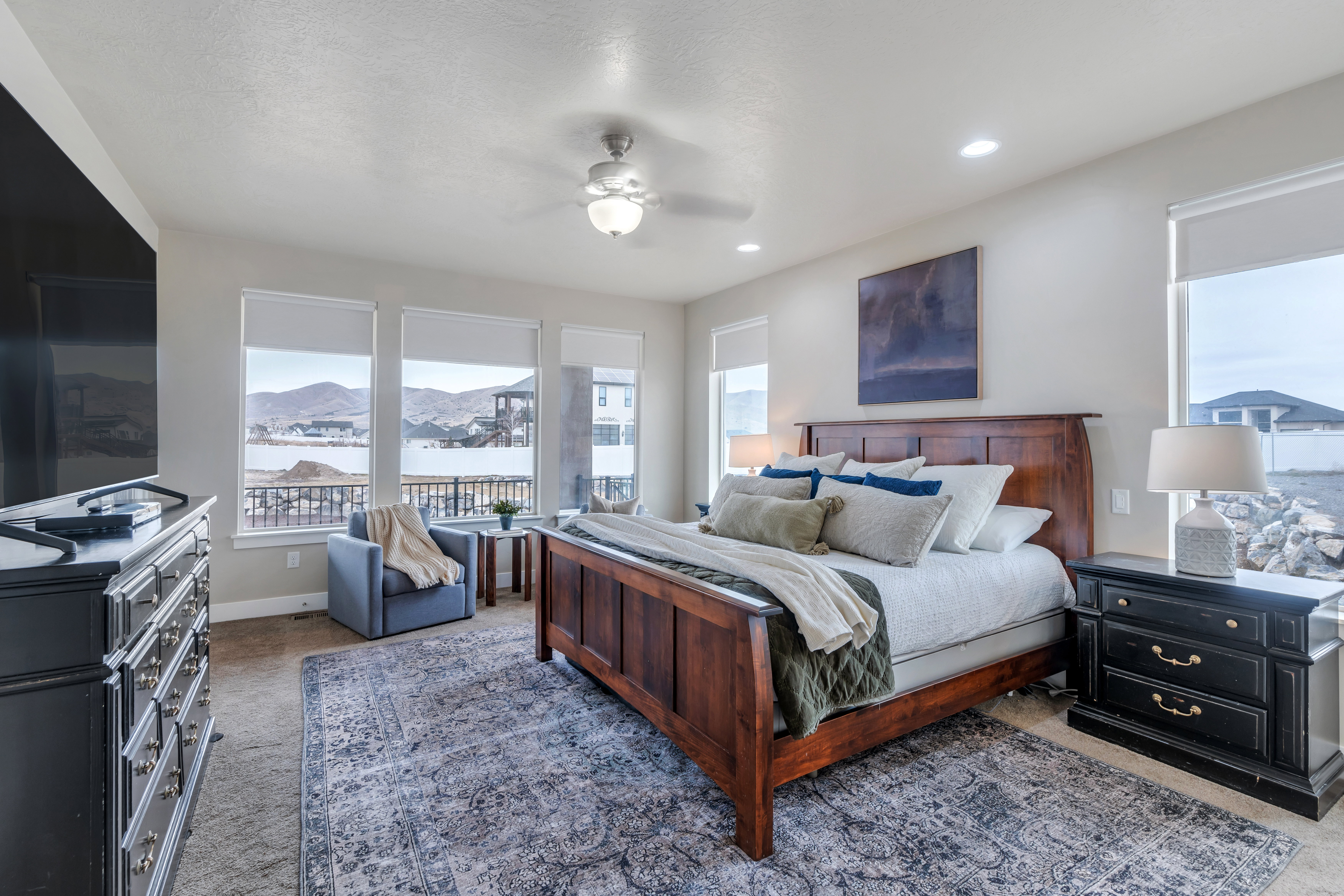 Carpeted bedroom with recessed lighting, a mountain view, baseboards, and ceiling fan