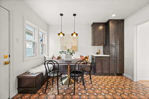 Dining room with baseboards, breakfast area, and recessed lighting