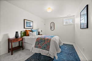 Bedroom featuring baseboards, visible vents, and carpet flooring