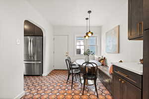 Dining area with arched walkways and baseboards