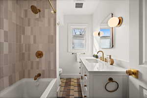 Full bath featuring visible vents, toilet, vanity, shower / tub combination, and baseboards